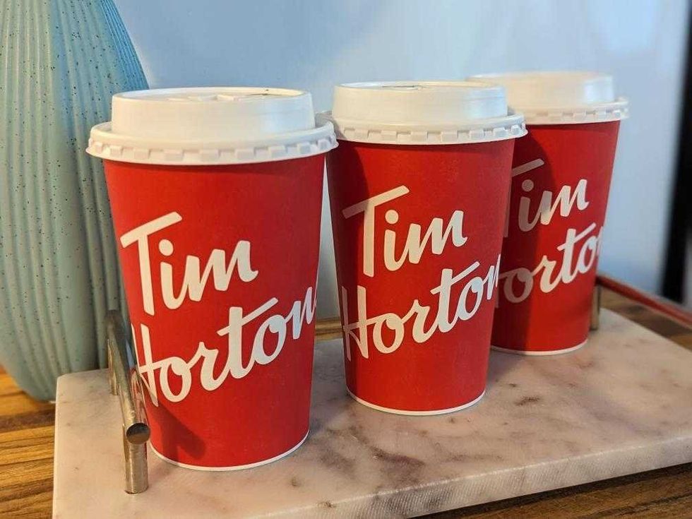 Three Tim Hortons cups lined up in Sarah's home.