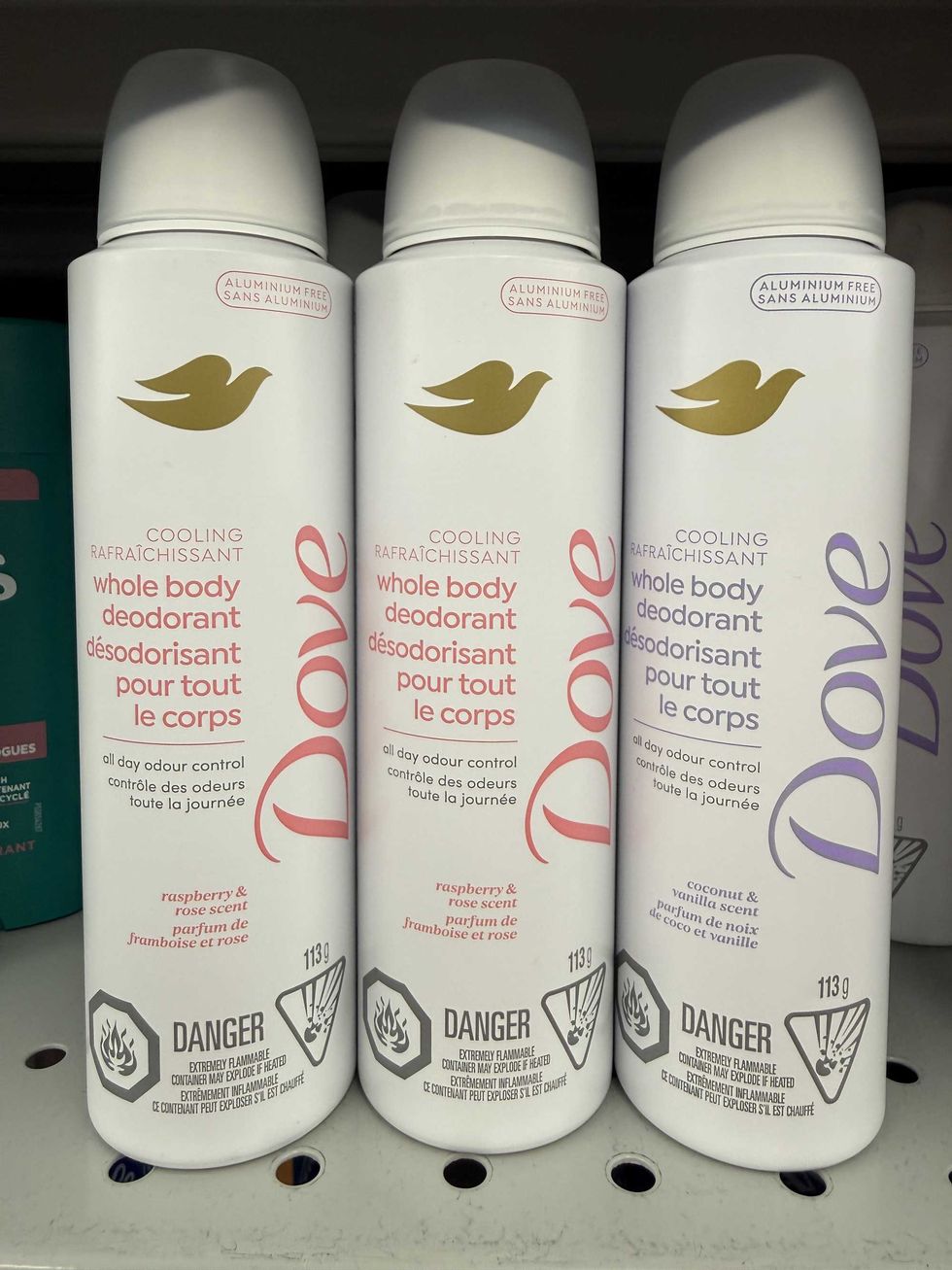 Three white canisters that say Dove cooling whole body deodorant.