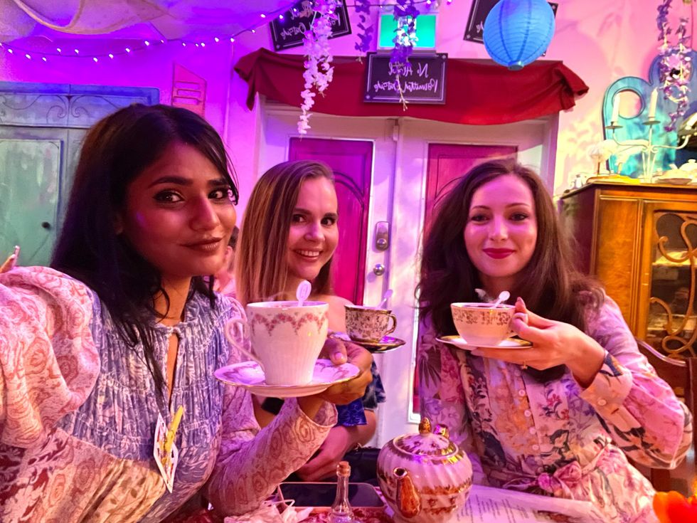 Three women holding teacups at The Alice.