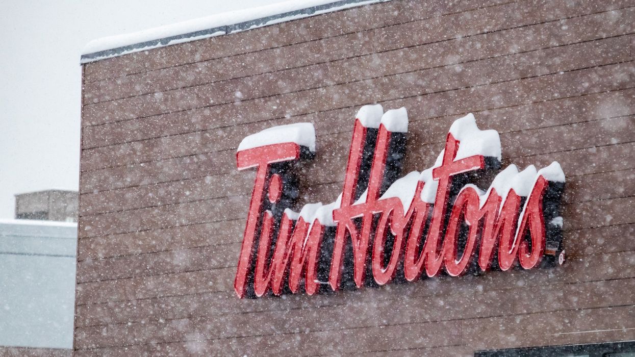 tim hortons sign on a location in canada covered in snow