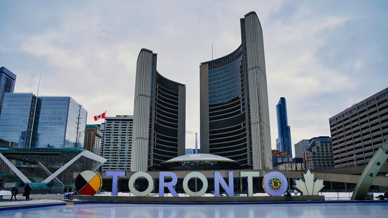 toronto city hall behind the toronto sign and skating rink