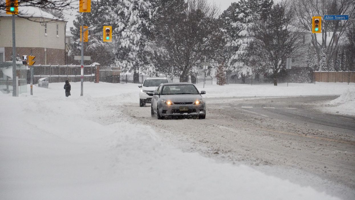 Toronto drivers travelling during a heavy snowfall.
