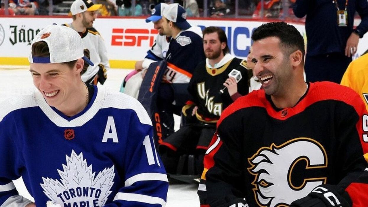 Toronto Maple Leafs' Mitch Marner and Calgary Flames' nazem Kadri laughing on the ice.