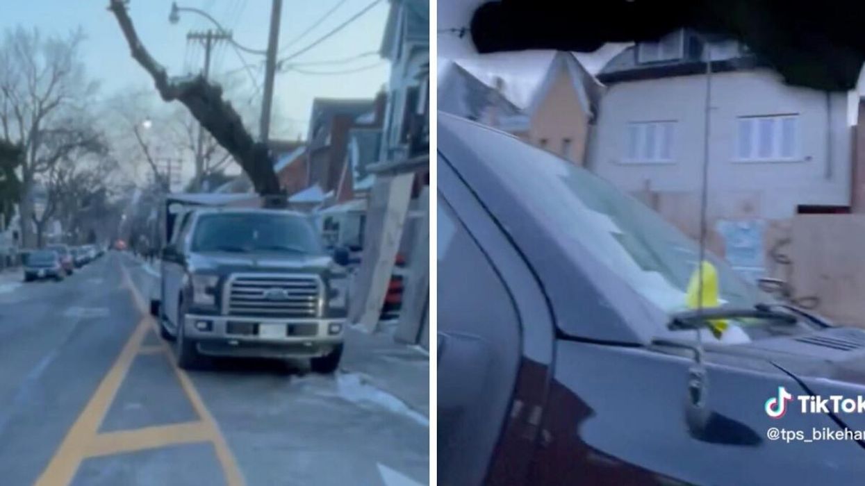 Toronto Parking Enforcement Officer issues a ticket to a truck parked in a bike lane.