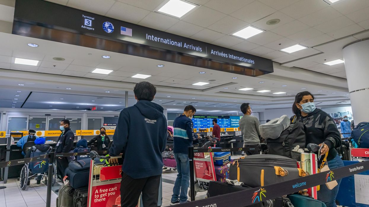 Toronto Pearson Airport fliers waiting in line at international arrivals.