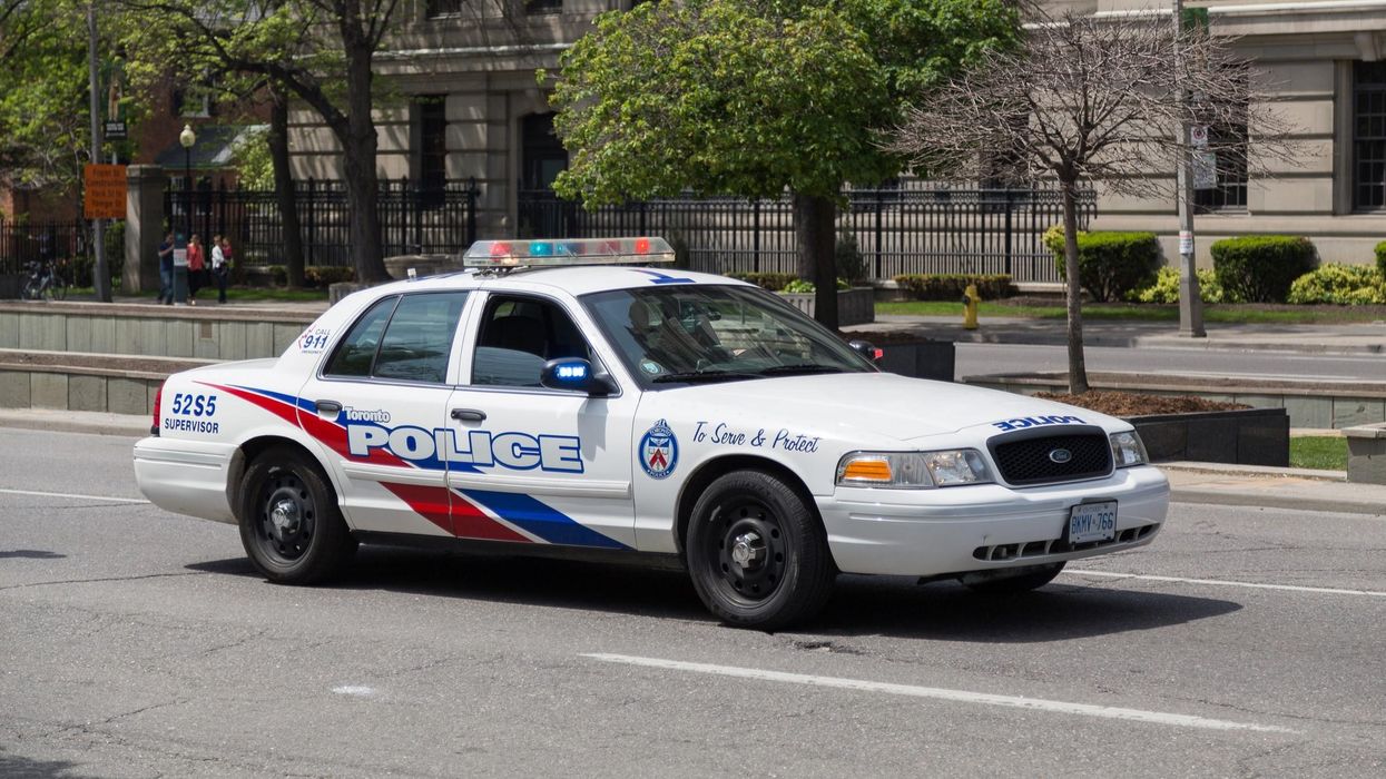 Toronto Police cruiser on a street with its lights flashing.