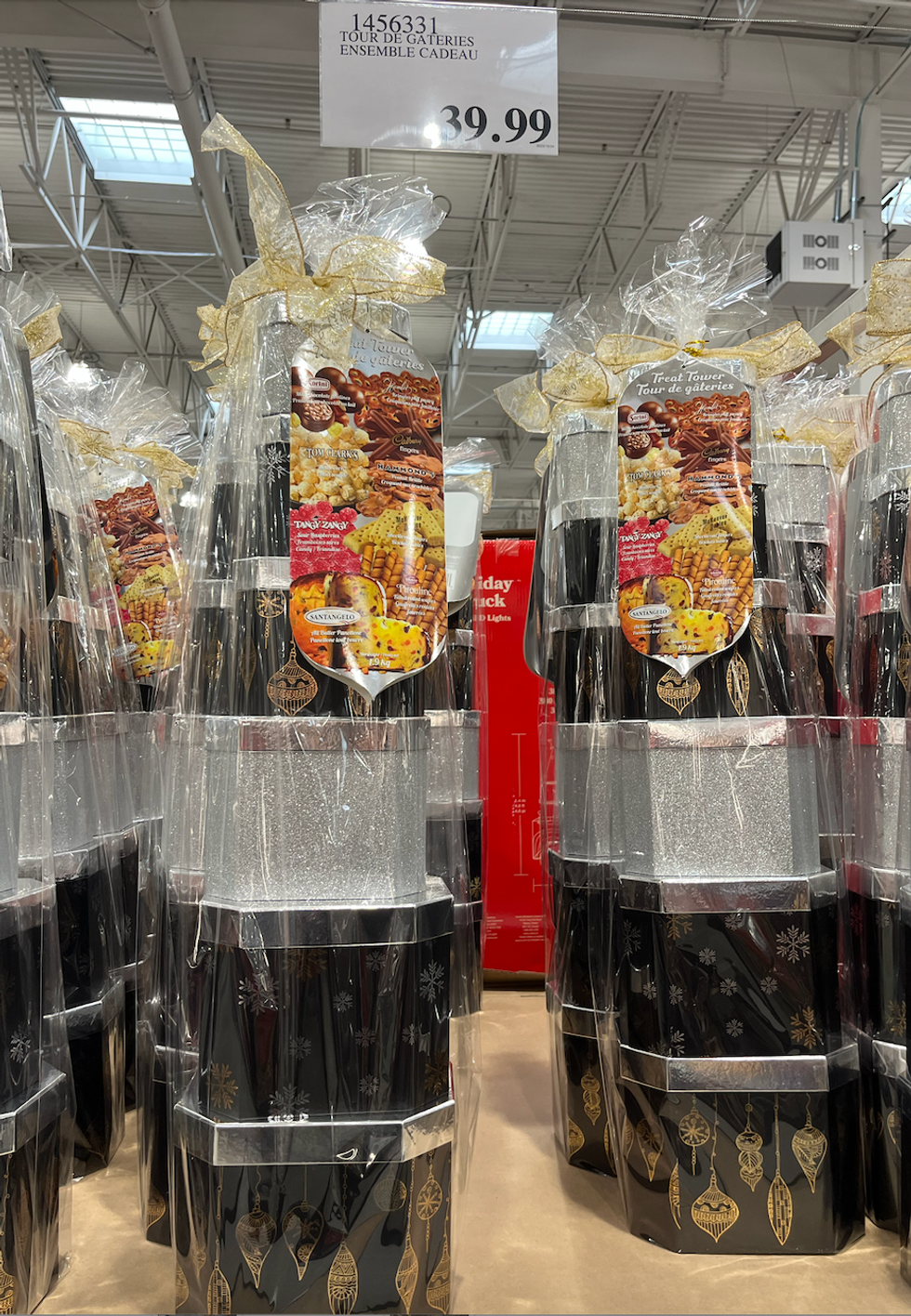 Tour de bo\u00eetes empil\u00e9es remplies de surprises sucr\u00e9es : chocolats, biscuits roul\u00e9s Pirouline, popcorn, et plus.