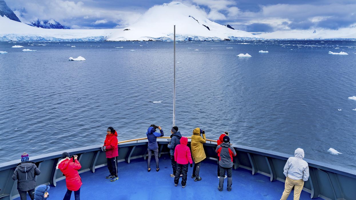 Tourists taking photos on a boat in Antarctica.