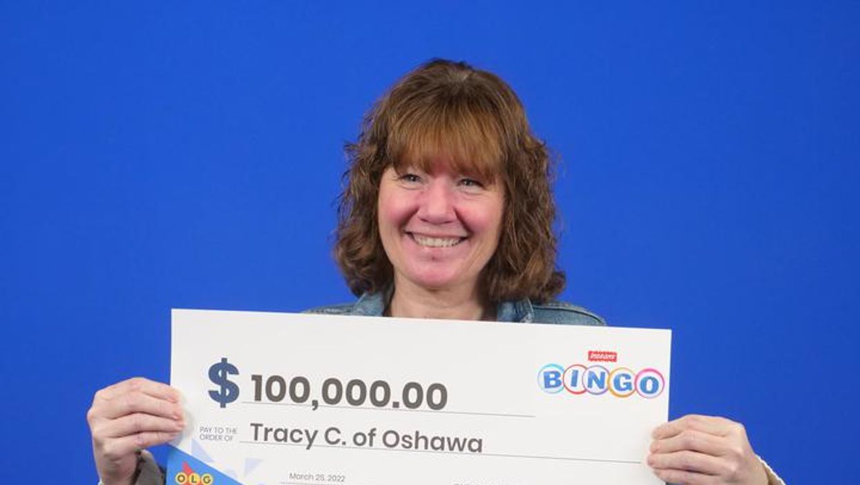 Tracy Campbell collecting her cheque for $100,000 at the OLG Prize Centre.