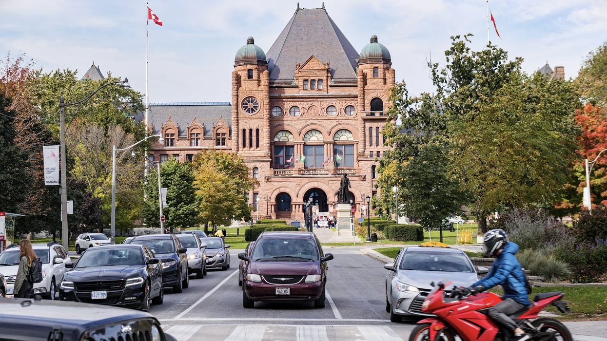 Traffic on the College Street and Queens Park in front of Legislative Assembly of Ontario building.