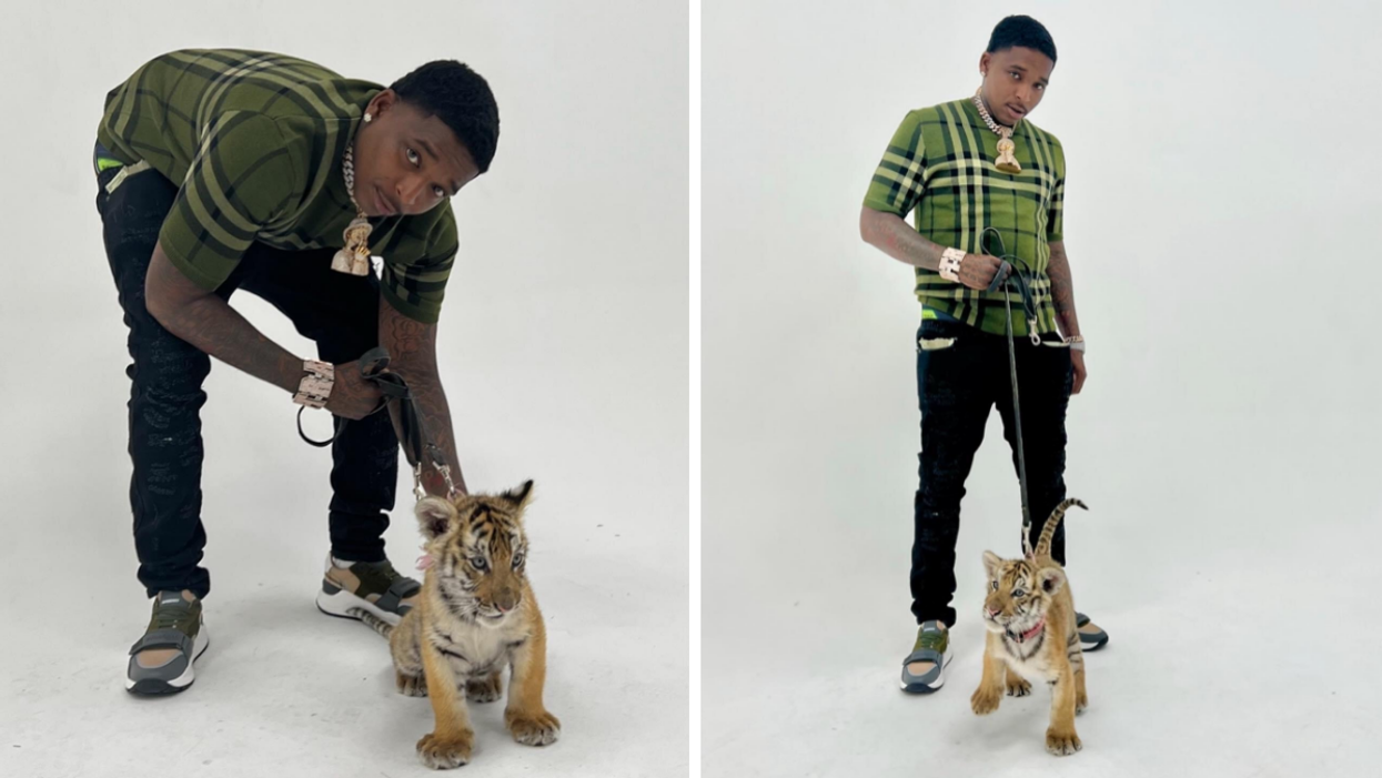 Trapboy Freddy holding a tiger cub on a leash.