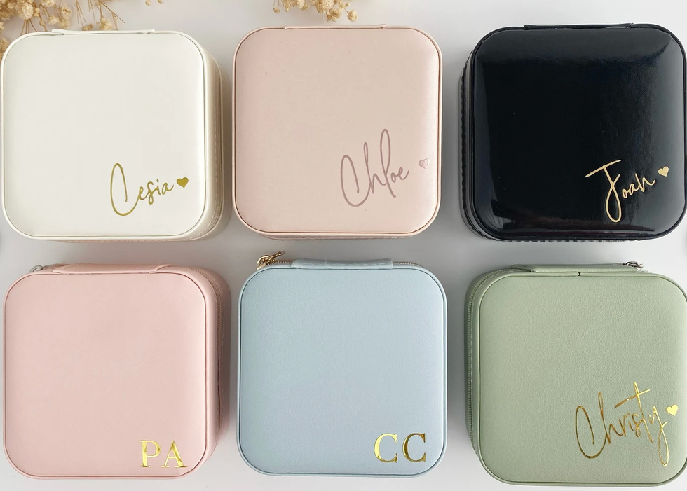 Travel jewelry cases in different colours with names or initials on them.
