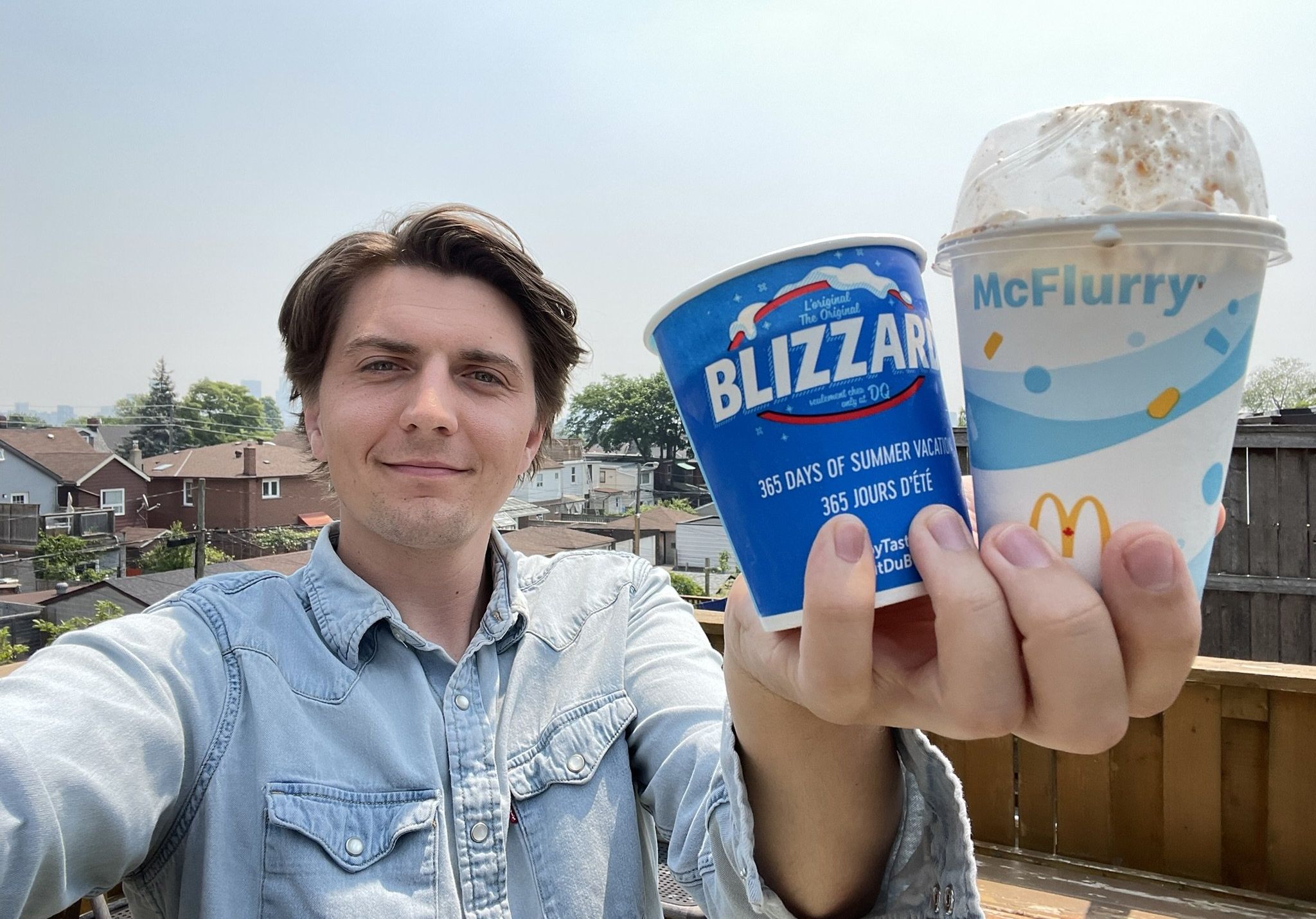 Tristan holding a DQ Blizzard and McDonald's McFlurry.