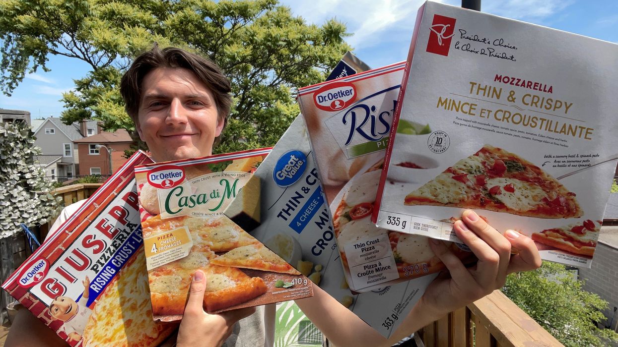 Tristan holding all the frozen pizzas.