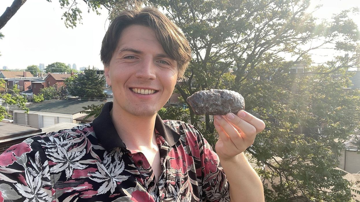 Tristan holding the Walnut Crunch donut.