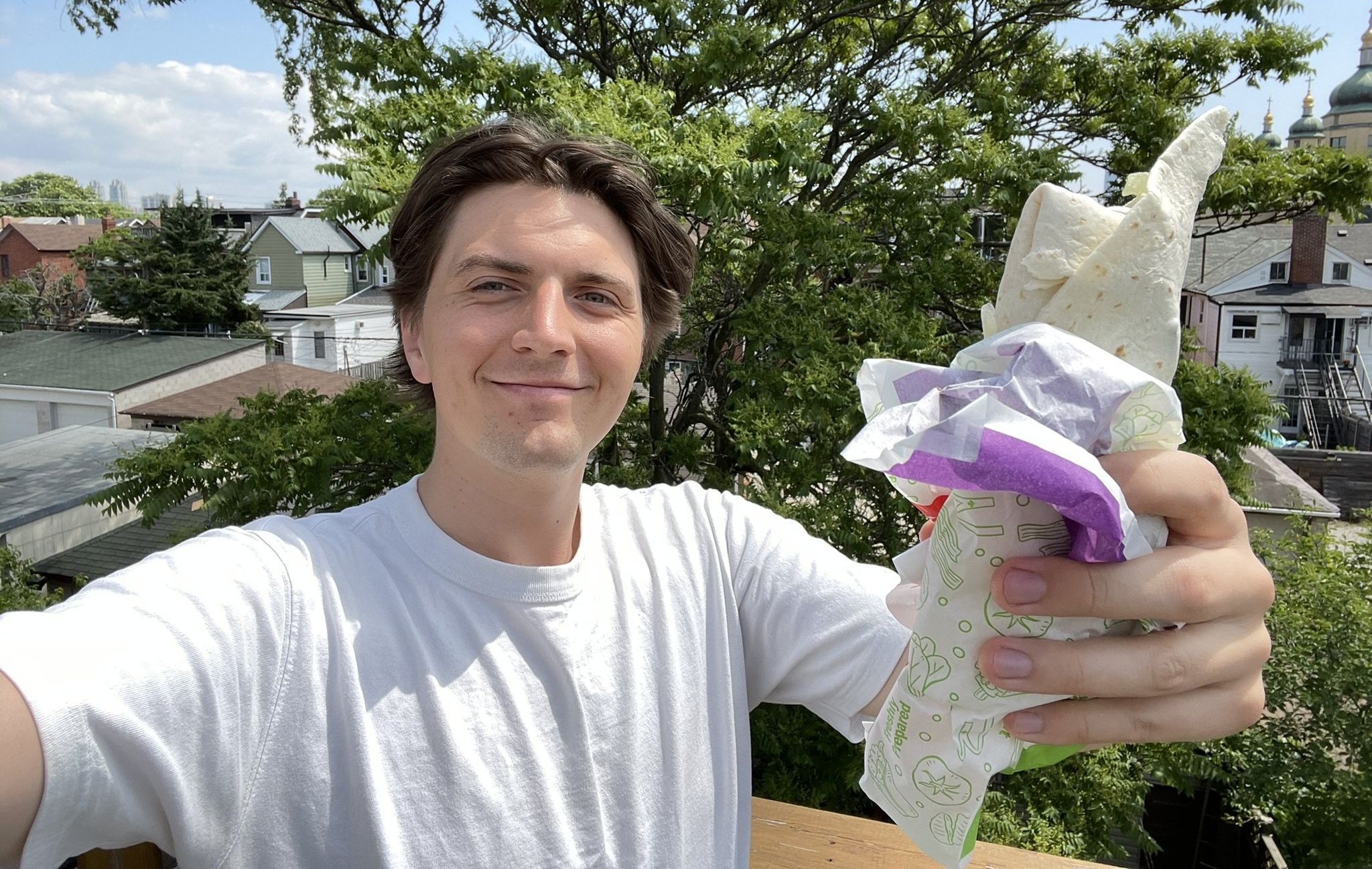 Tristan Wheeler holding a McDonald's wrap.