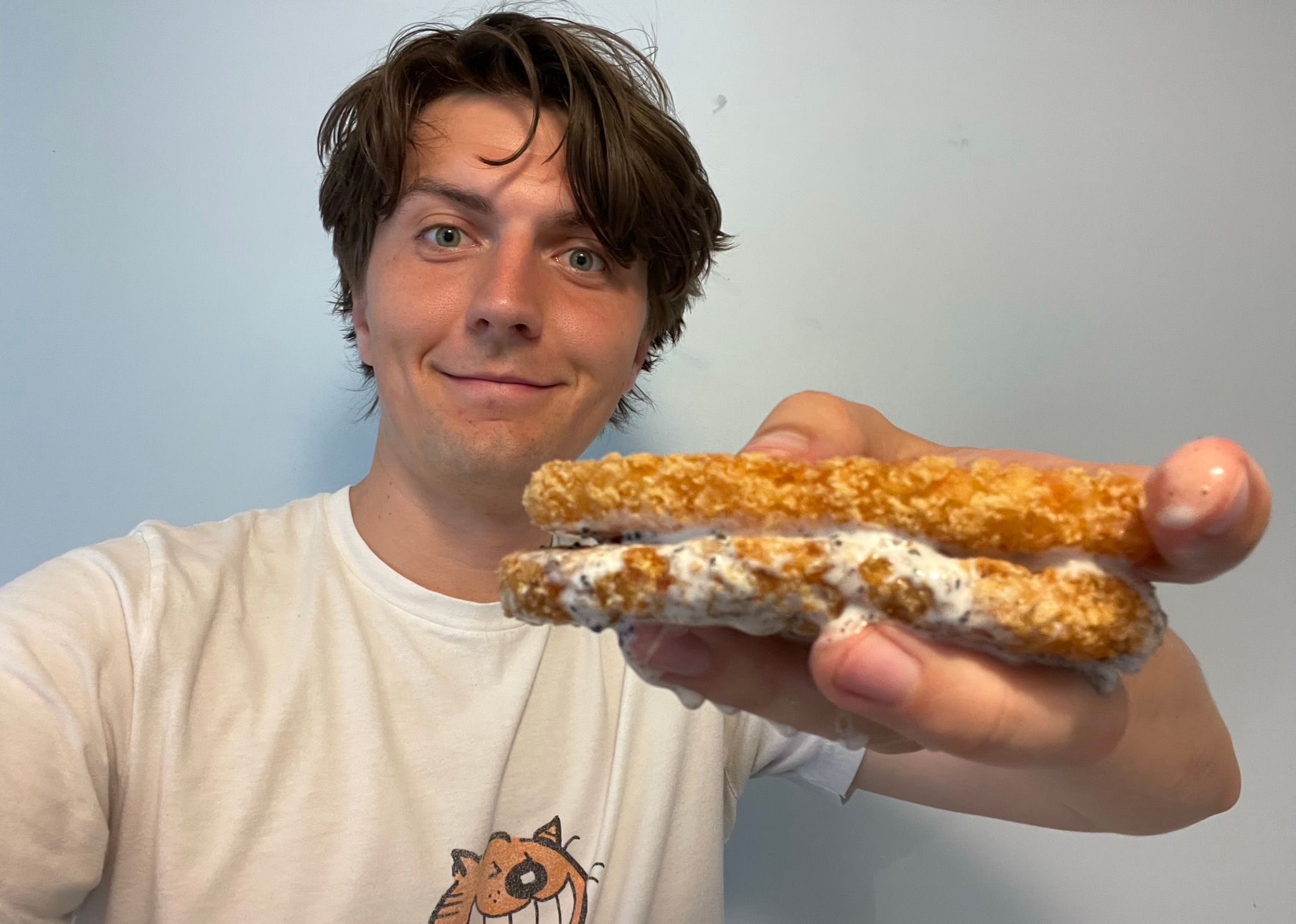 Tristan Wheeler holding the McDonald's McFlurry and hash brown sandwich.