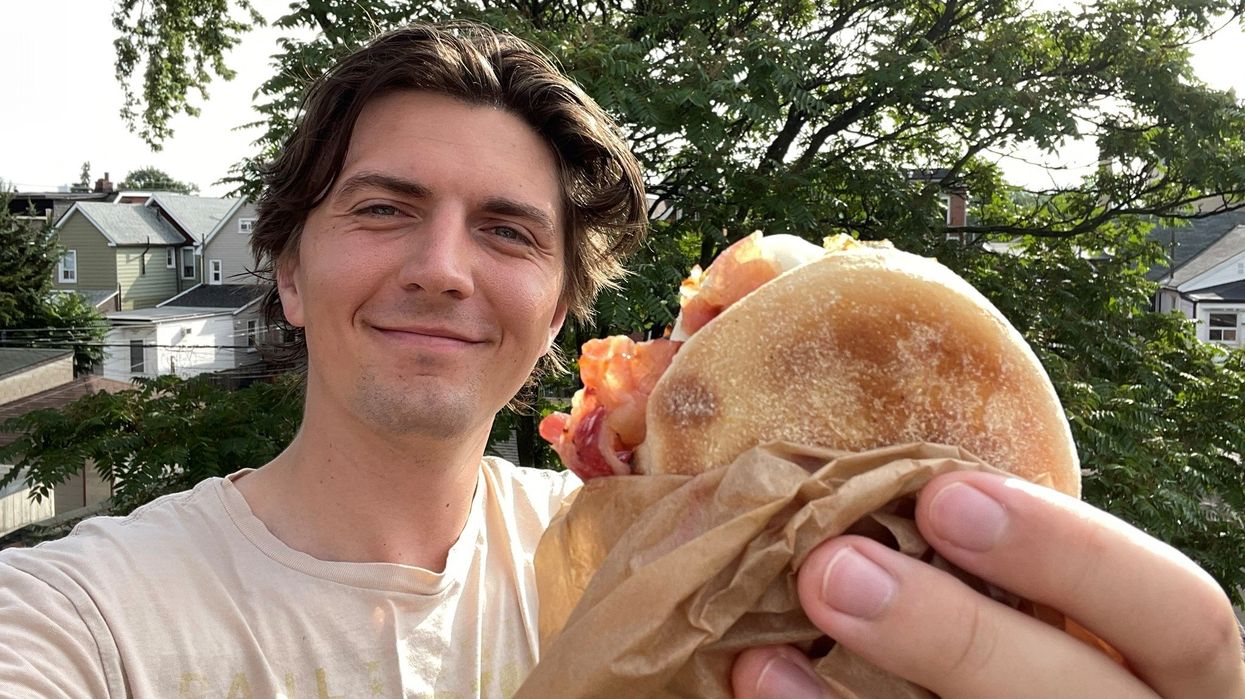 Tristan Wheeler holding the new breakfast sandwich.