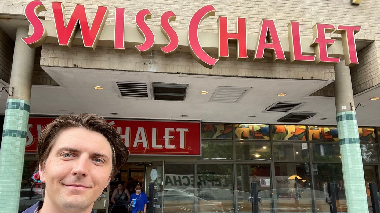 Tristan Wheeler in front of a Swiss Chalet.