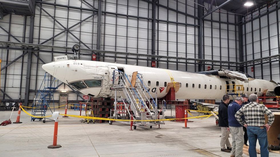 TSB officials examine the aircraft at the GTAA hangar.