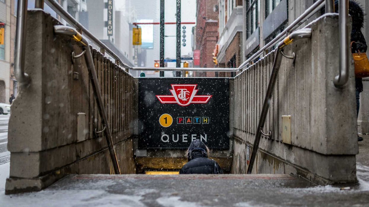 ttc sign at the entrance to the queen subway station