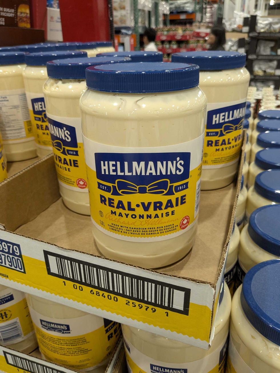 Tubs of mayonnaise stacked in a box