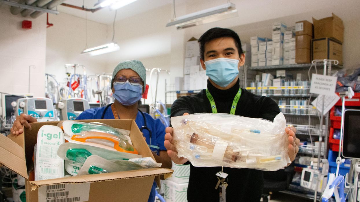 TWH Respiratory Therapist Lisa Kappukatt and Energy & Environment Sustainability Coordinator Warren Marasigan hold up medical supplies donated to Operation Green.