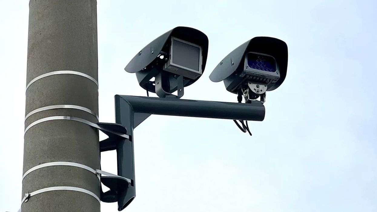 Two automatic speed cameras on a pole.