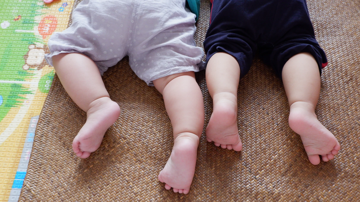 Two babies lie side by side.