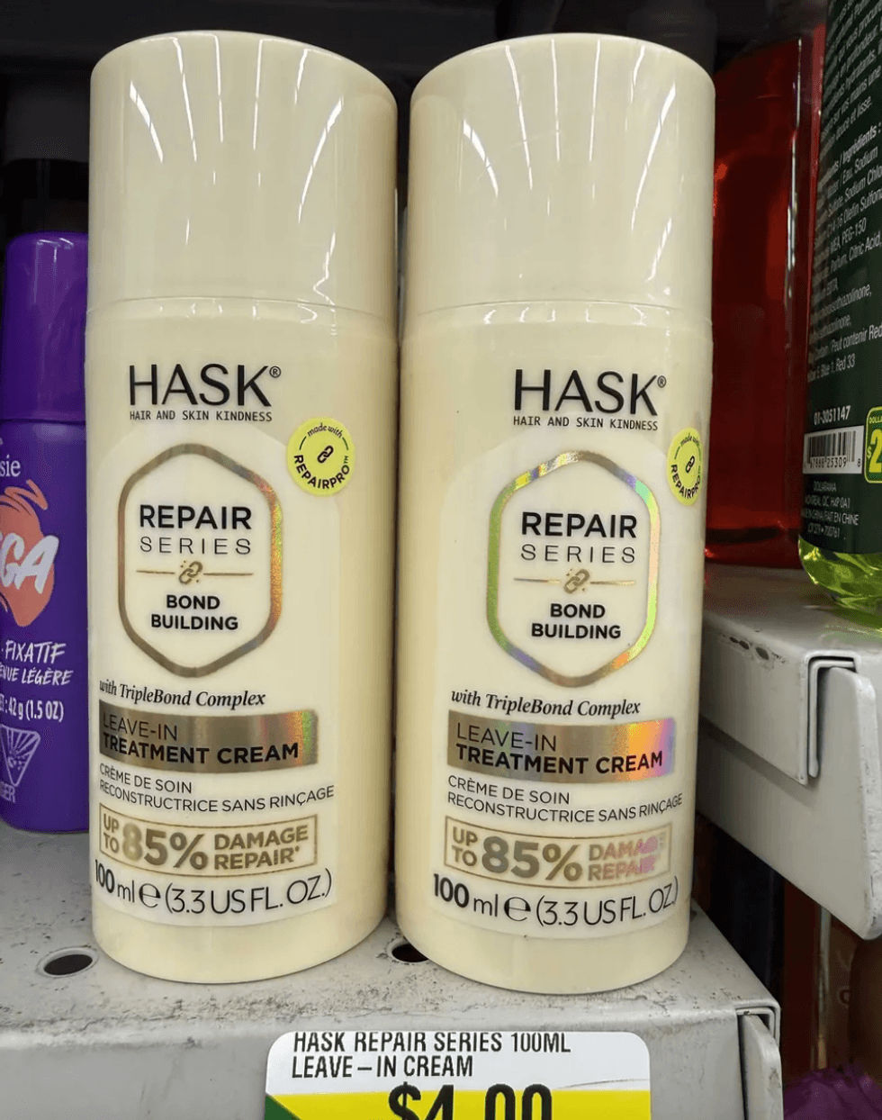 Two bottles of Hask Repair Series Leave-In Cream on a store shelf, priced at $4.00.