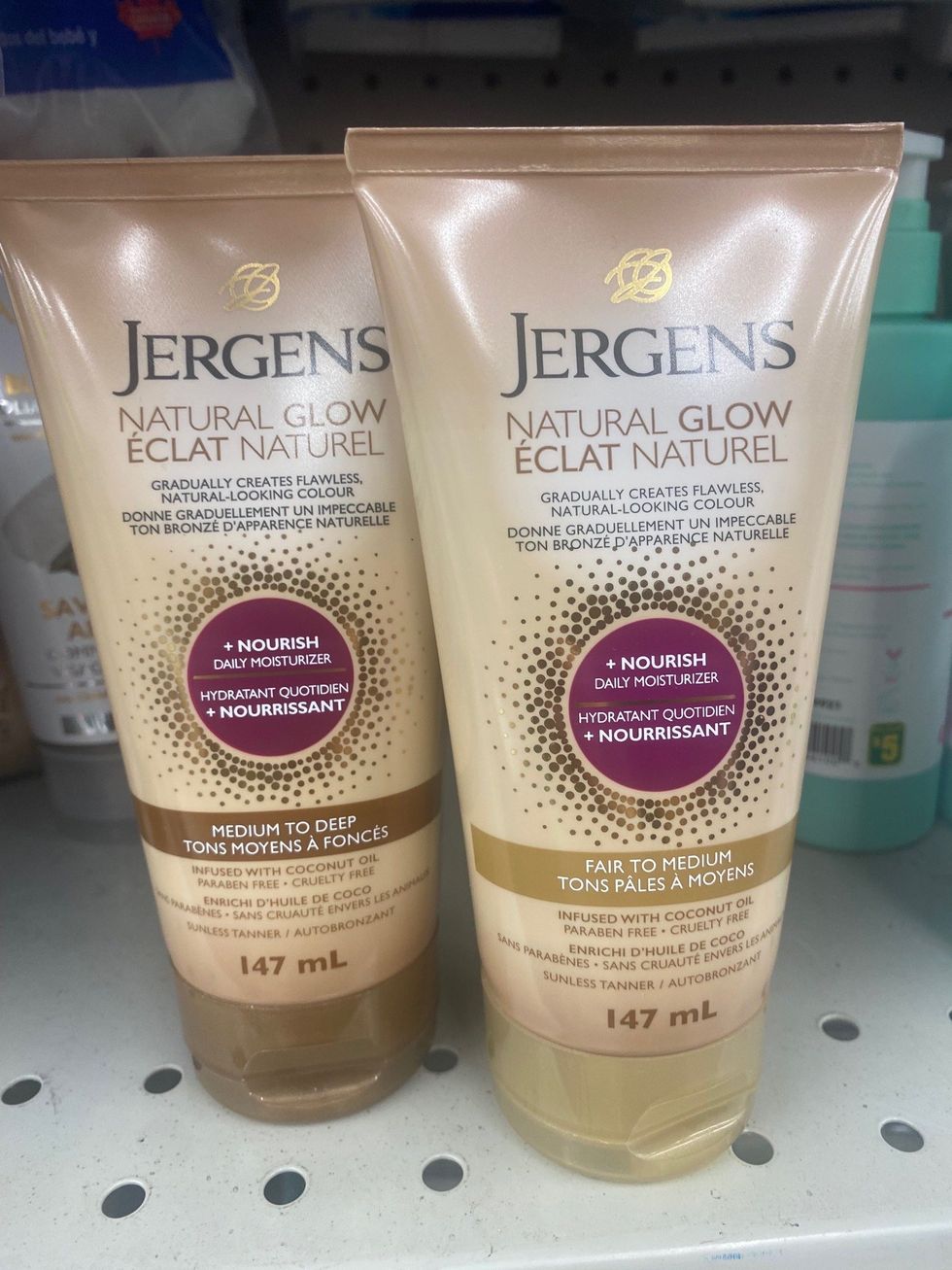 Two brown bottles of moisturizer on a store shelf.
