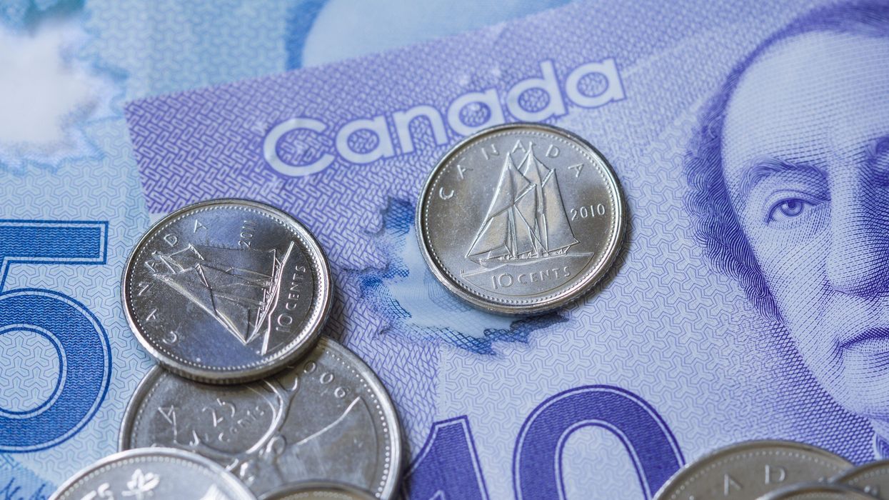 two canadian dimes on a $10 bill