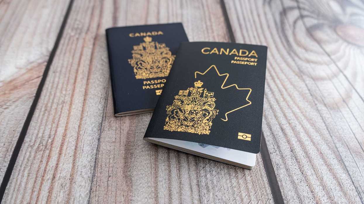 two canadian passports with new and old designs on a table