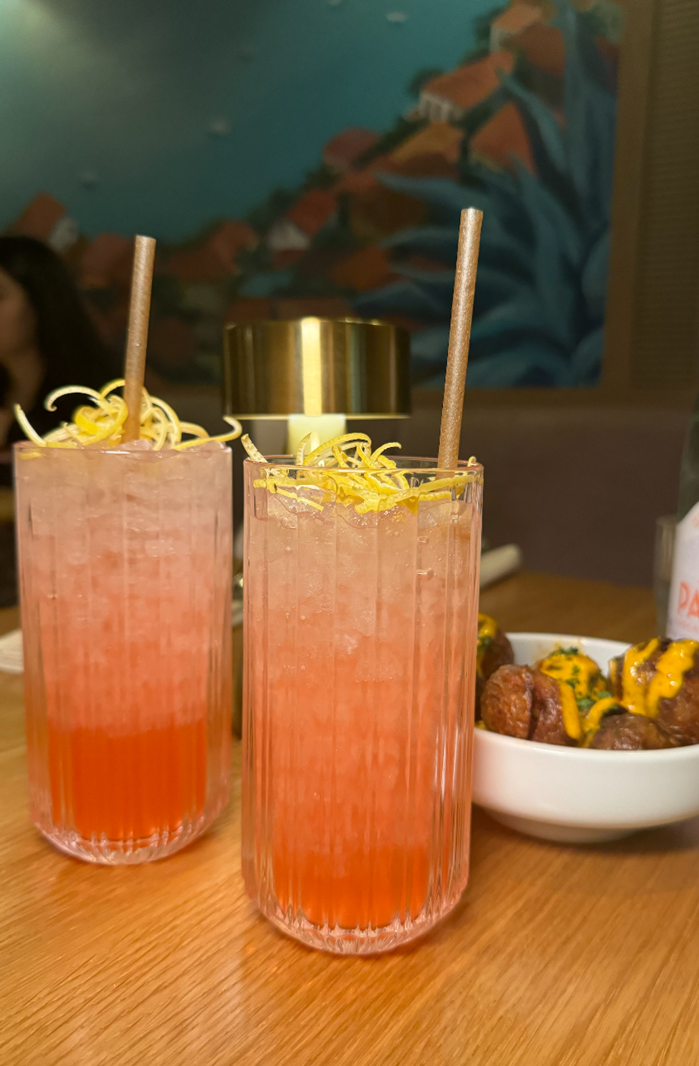 Two cocktails and Patatas Bravas from Abrielle.