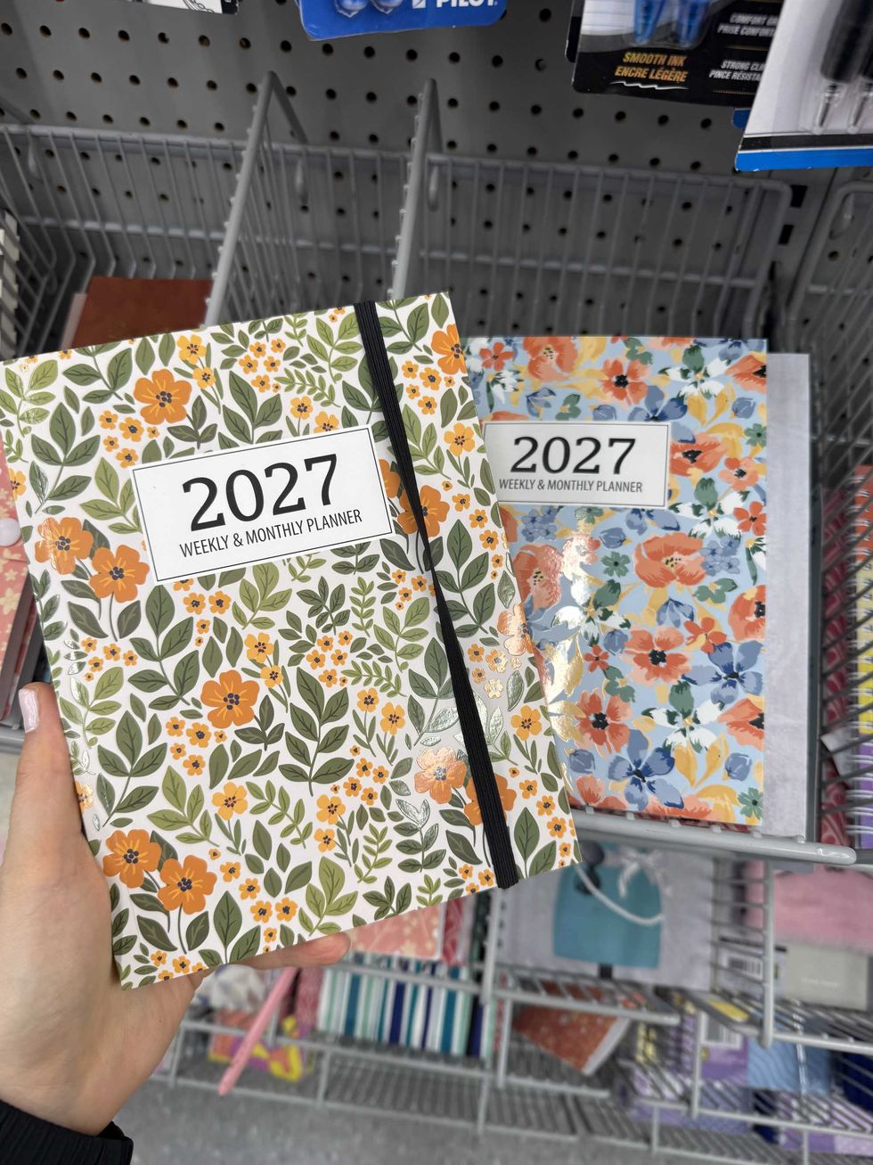 Two colourful 2027 planners with floral designs on them.
