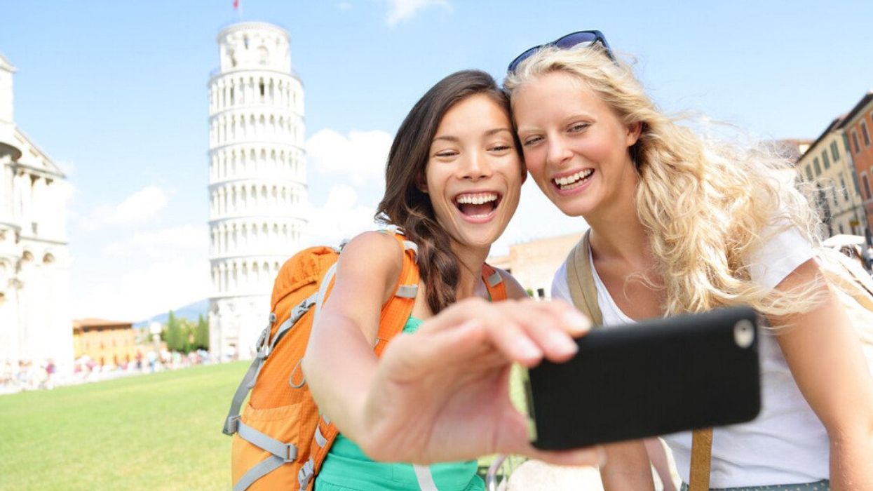Two friends taking a photo in Pisa, Italy.