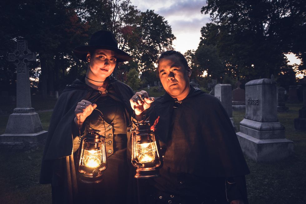 Two ghost tour guides in an Ottawa cemetery.