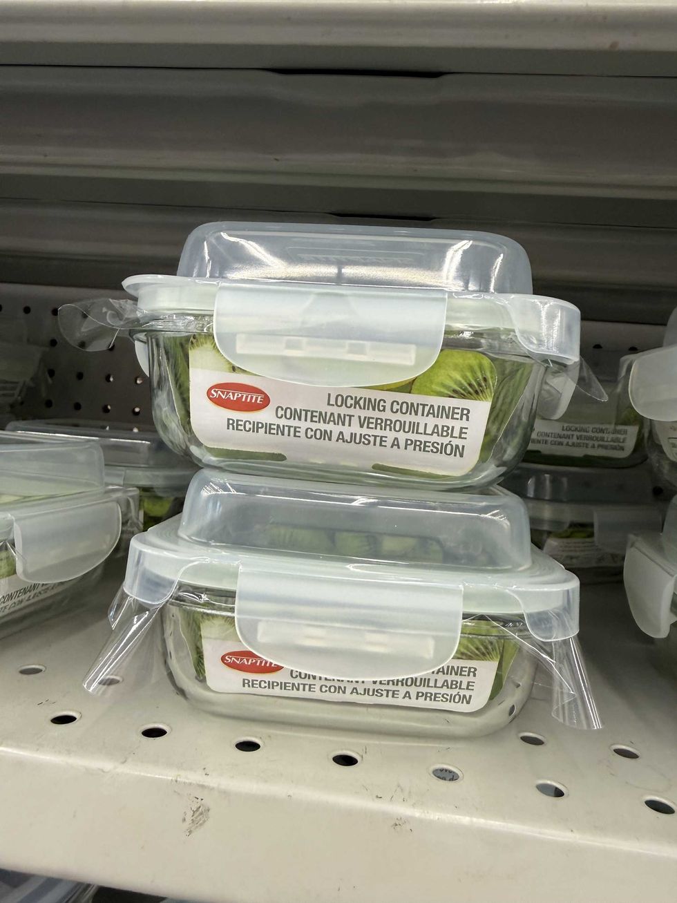 Two glass containers with lids sitting on a store shelf.