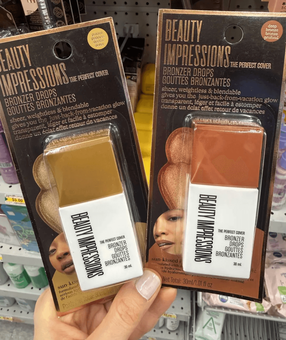 Two hands holding Beauty Impressions bronzer drops in a store aisle.