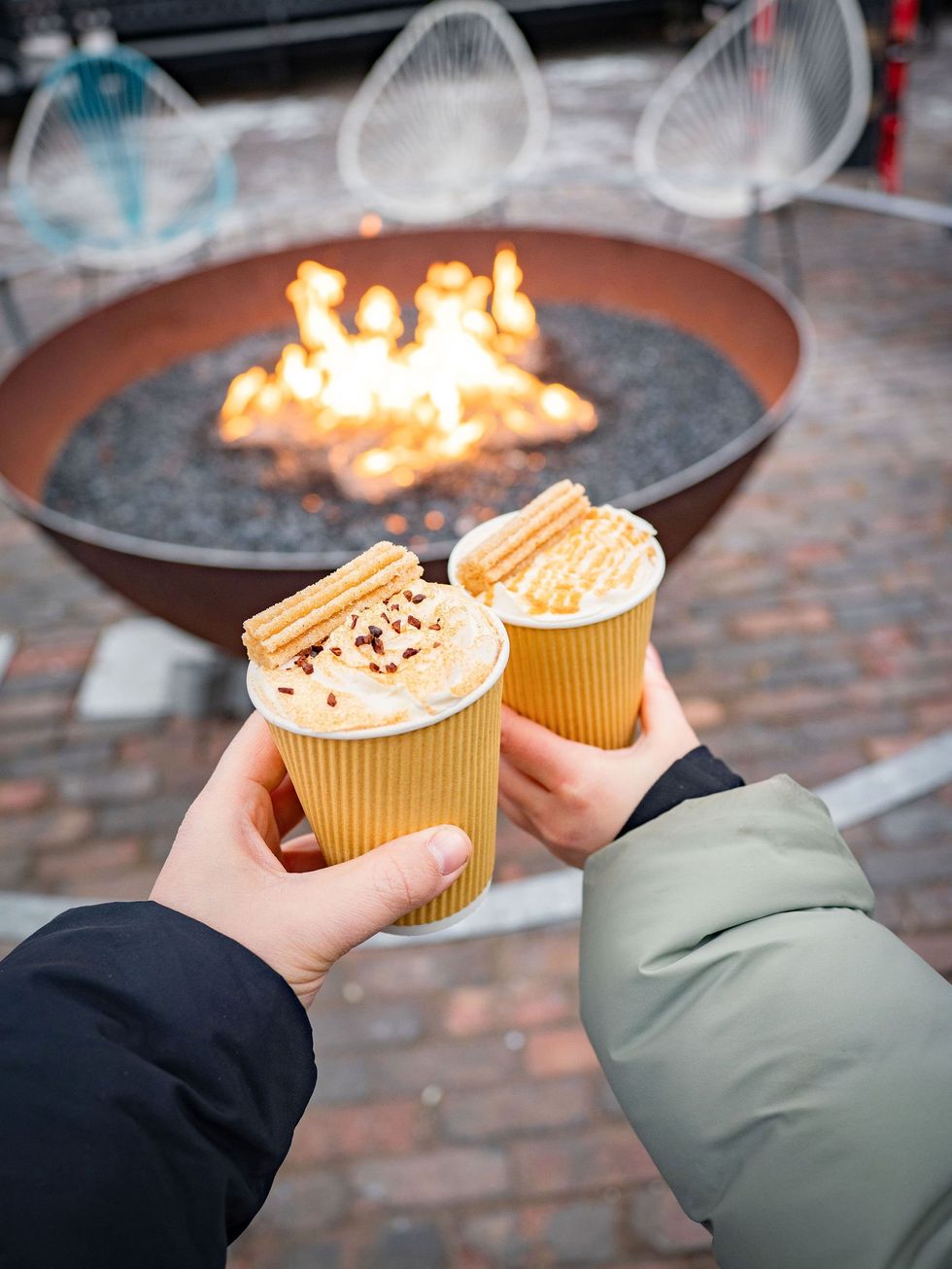 Two hands holding hot chocolate.