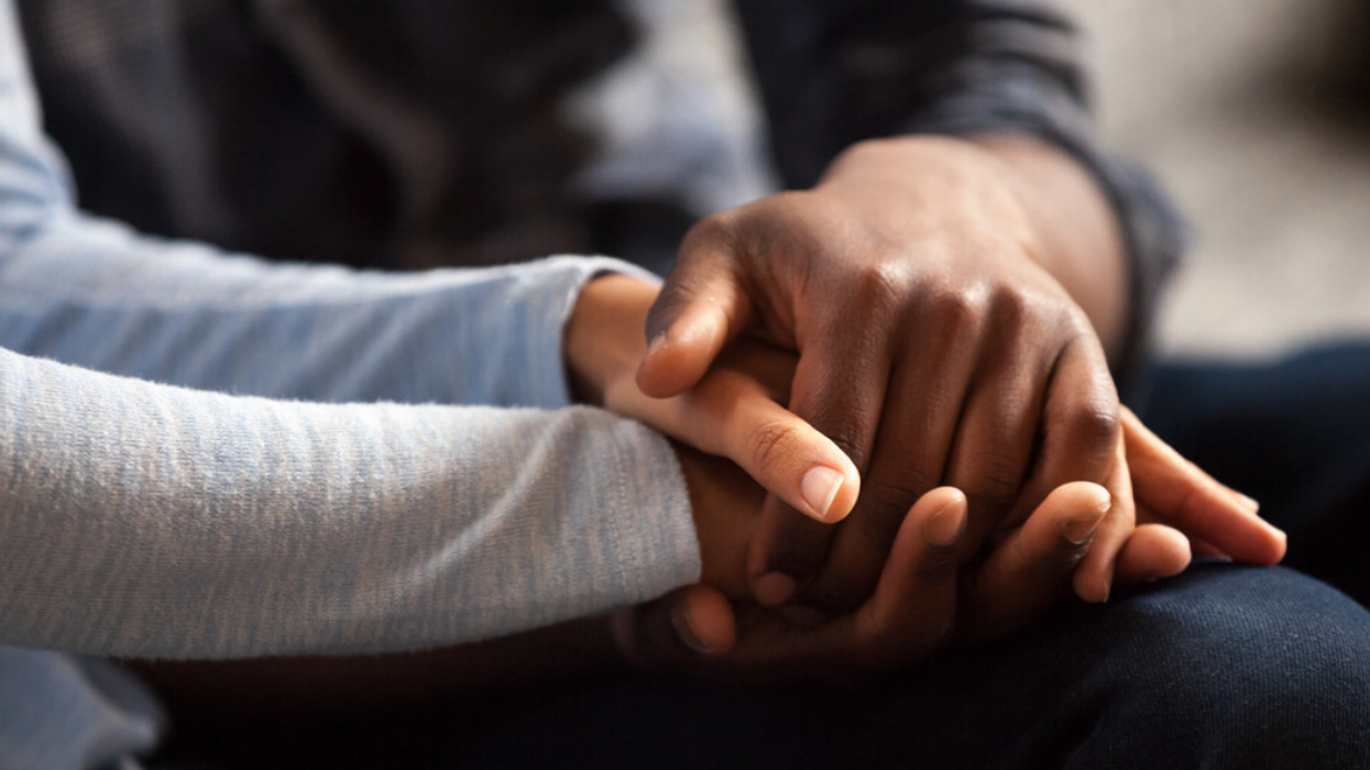 Two people holding hands.