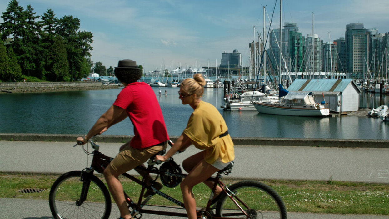 Two people on a tandem bike in Vancouver, BC.