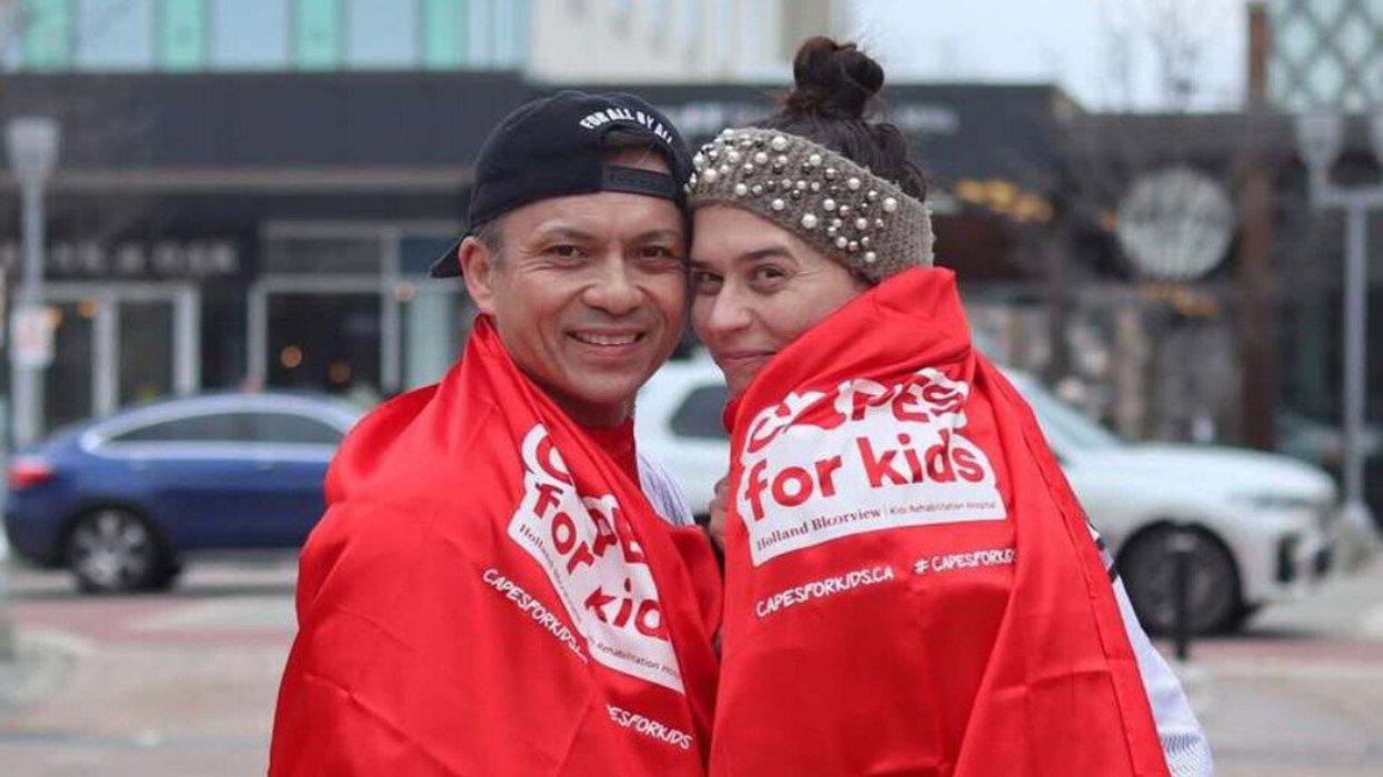 Two people wearing Capes for Kids red capes.