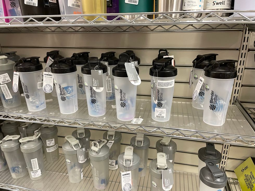 Two shelves of water bottles.