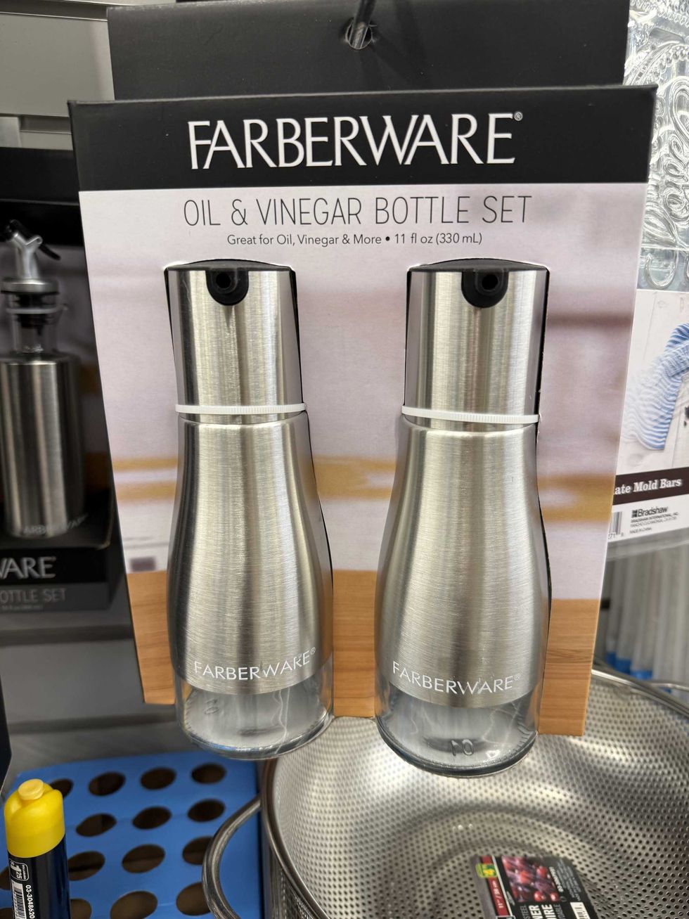 Two stainless steel bottles that say oil and vinegar bottle set on the tag.