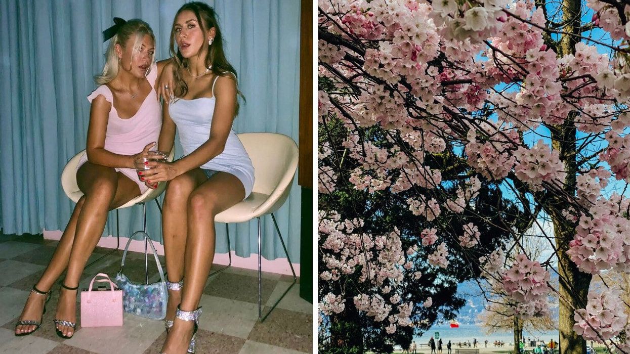 Two women dressed in pastel mini dresses sit side by side on modern chairs, holding drinks and posing in front of a curtain. Right: Pink cherry blossoms in full bloom frame a scenic beachside view with people walking in the background under a clear blue sky.