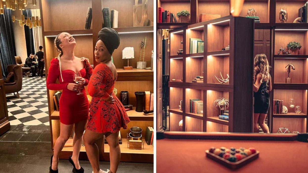 Two women in front of the bookcase door at D/6 Bar & Lounge. A woman walking into the bookcase door at D/6 Bar & Lounge.
