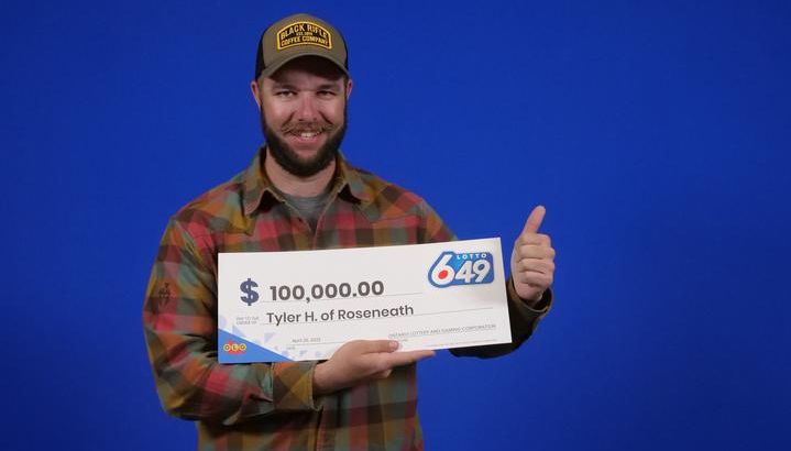 Tyler Hynes picking up his cheque for $100,000.