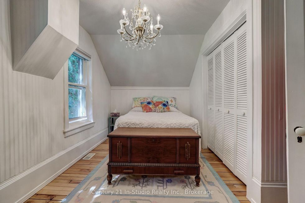 \u200bA bedroom with a chandelier.