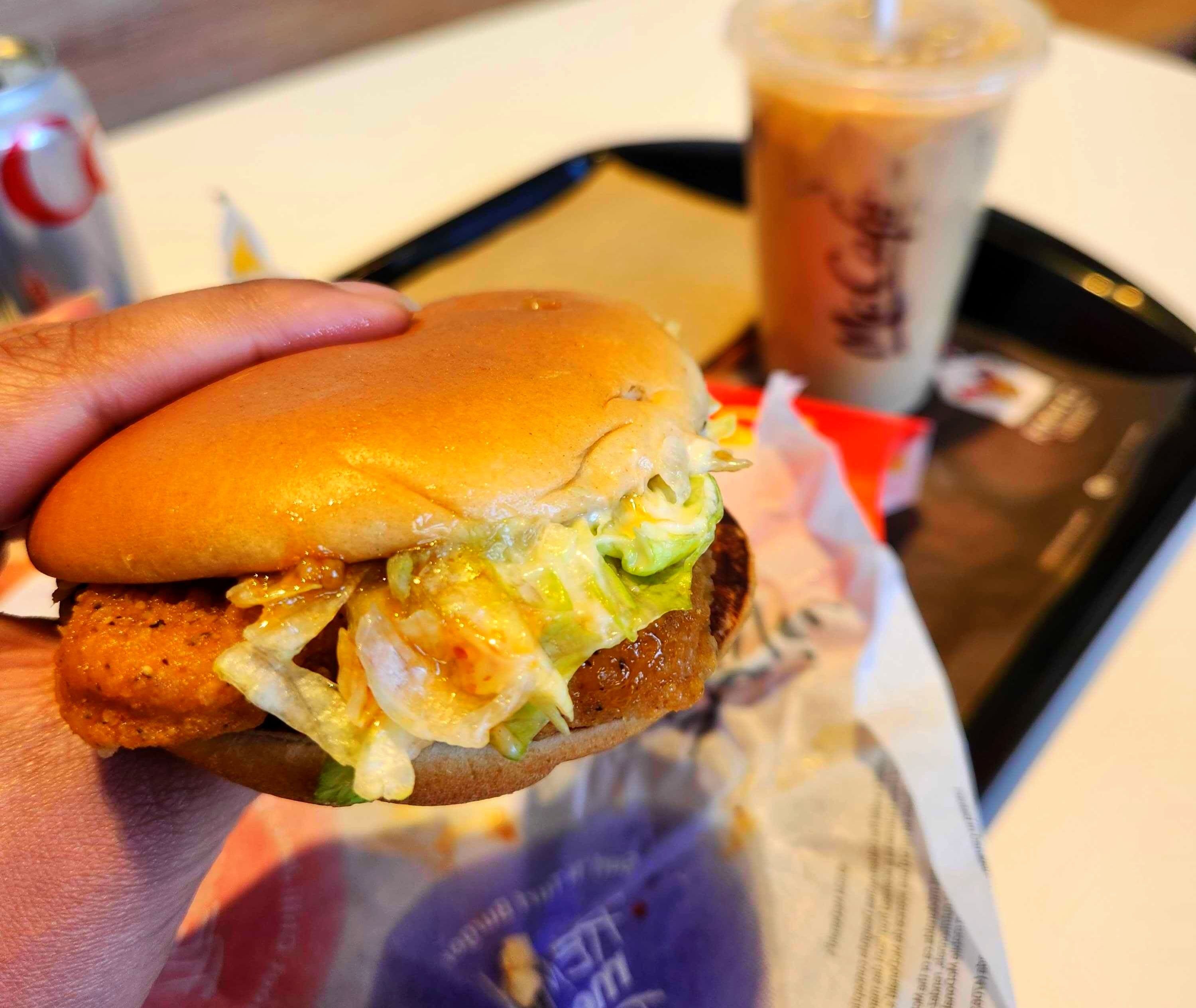 \u200bA hand holding a Sweet Chili Junior Chicken.